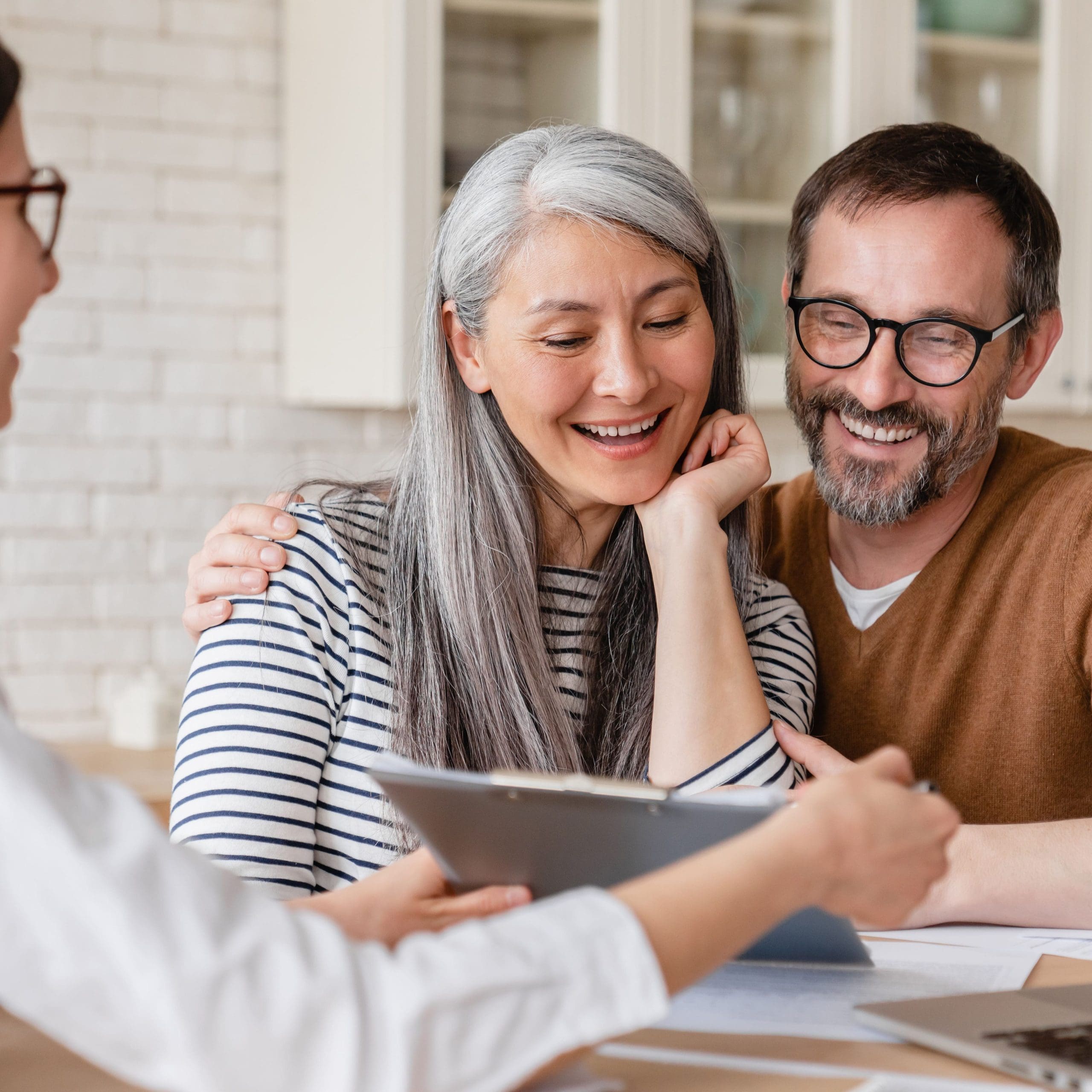 financial advisor helping consulting showing contract mortgage loan credit business startup, signing documents by matute middle-aged couple at home