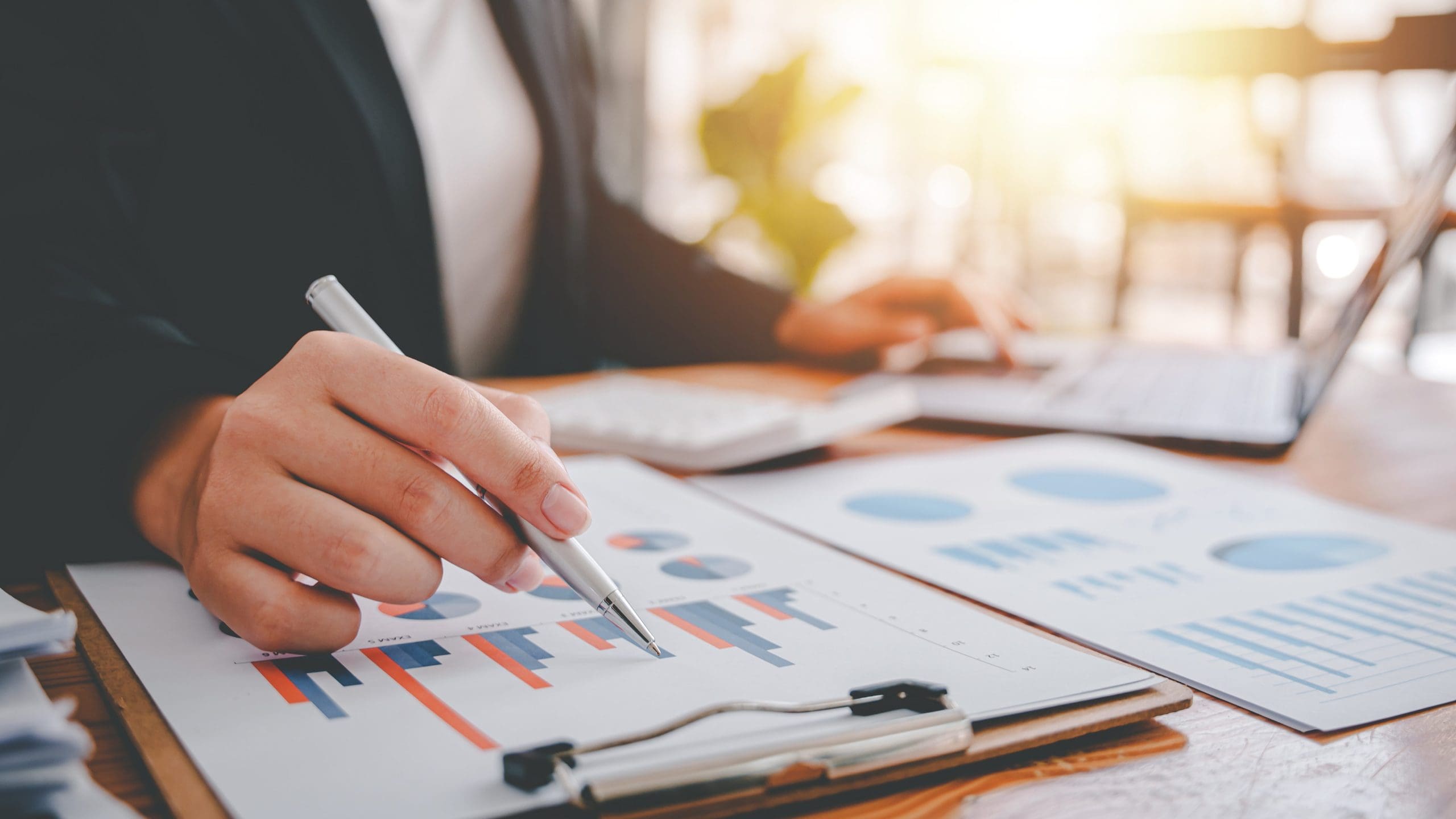 Portrait of a woman working on a tablet computer in a modern office. Make an account analysis report. real estate investment information financial and tax system concepts